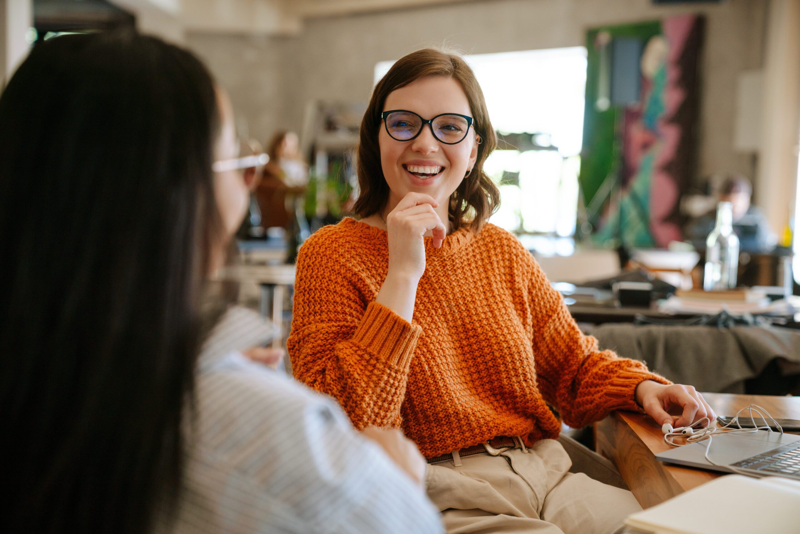 Multiracial young colleagues discussing project while working in office