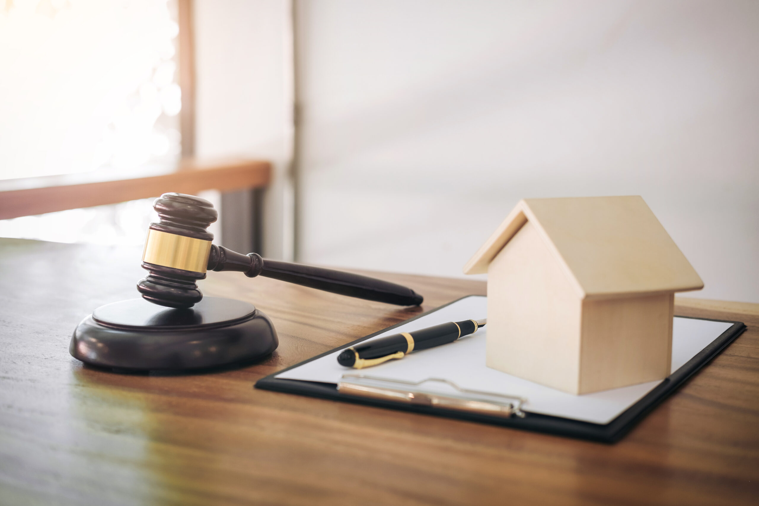Gavel on sounding block at courtroom for decide home insurance, Law and justice concept, Settle a house dealing lawsuit