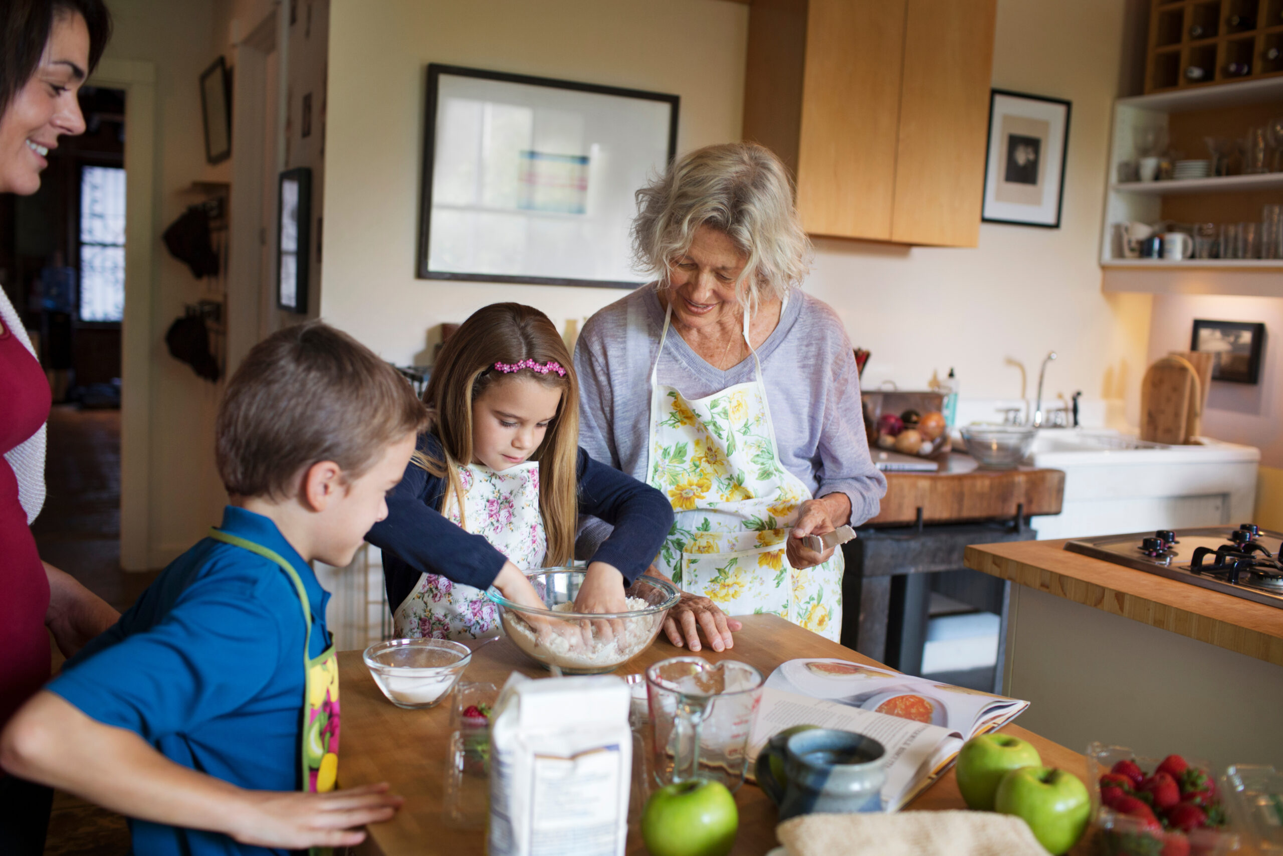 Grandma with her grandchildren and daughter in kitchen